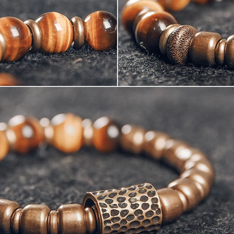 Close-up macro view of tiger eye stone texture and hammered copper metal spacer beads