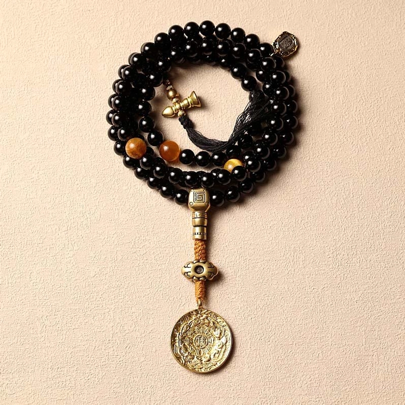 Tiger eye stone beads with natural cat-eye grain texture displayed on wooden tabletop, showcasing golden striped pattern