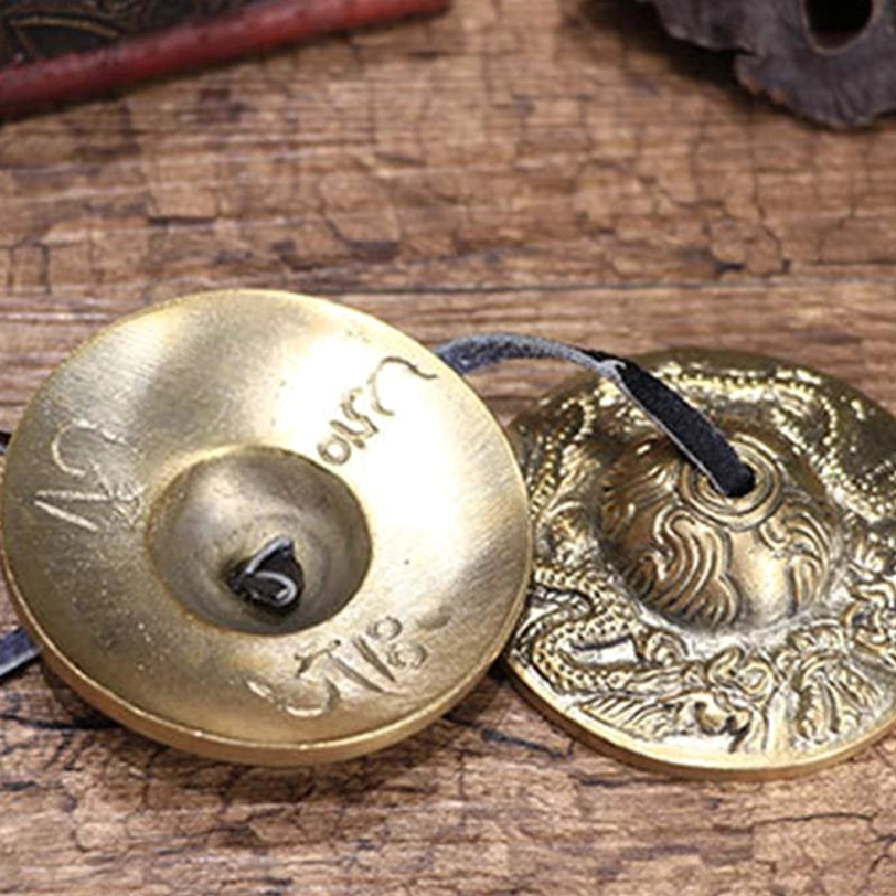 Tibetan tingsha bells leather cord connection detail showing traditional construction for sound healing