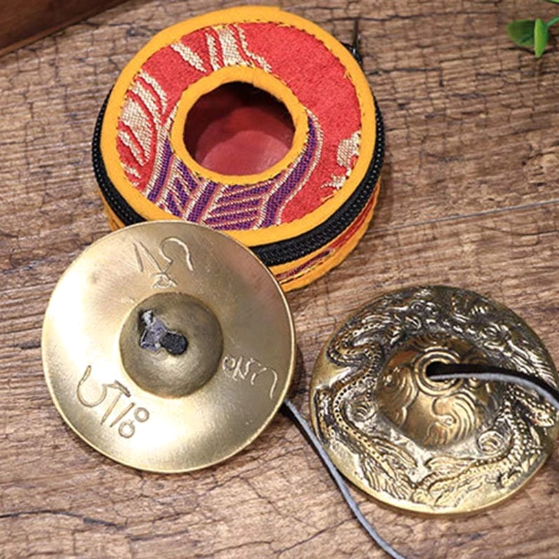 Brass tingsha cymbals set with protective fabric pouch for meditation and mindfulness practice