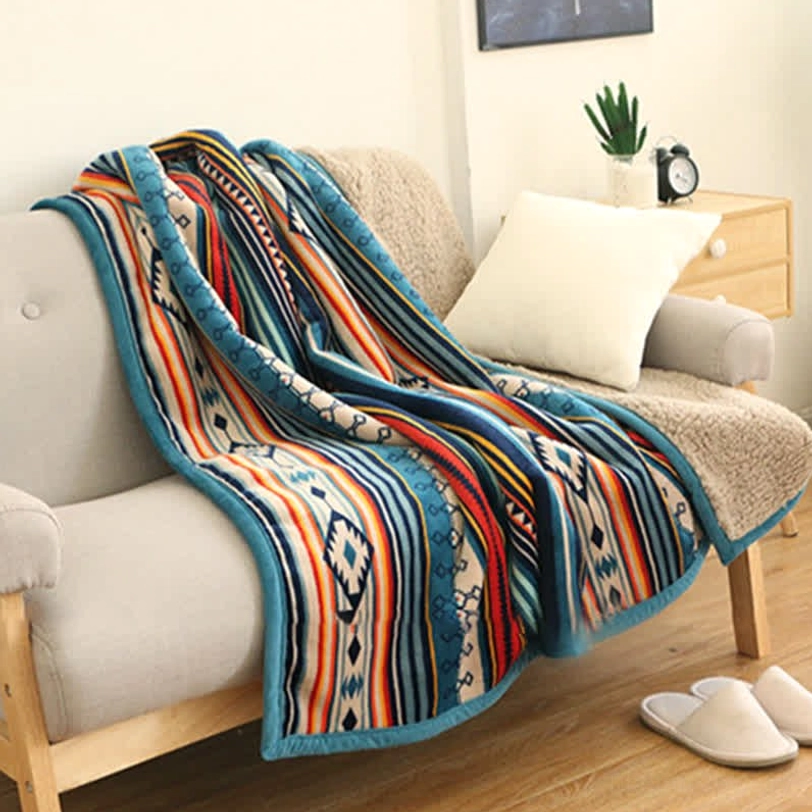 Single sofa throw blanket with sherpa fleece reverse and tribal geometric print in warm living room setup, bohemian home decor