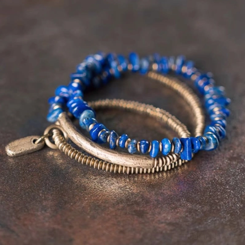 Triple wrap lapis lazuli bracelet set showing layered stacking design with metal tag on leather background