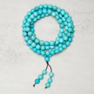 Authentic 108 turquoise bead mala bracelet with brown tassel and counter beads - flat lay top view showing round natural turquoise beads