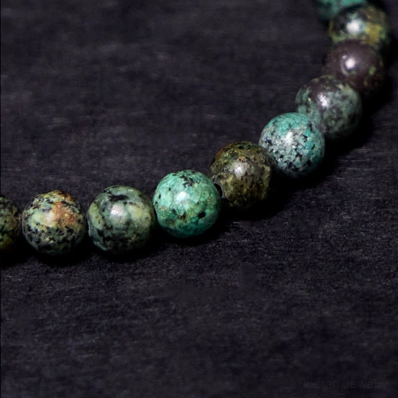 Turquoise stone beads in earthy tones with copper accents macro photography