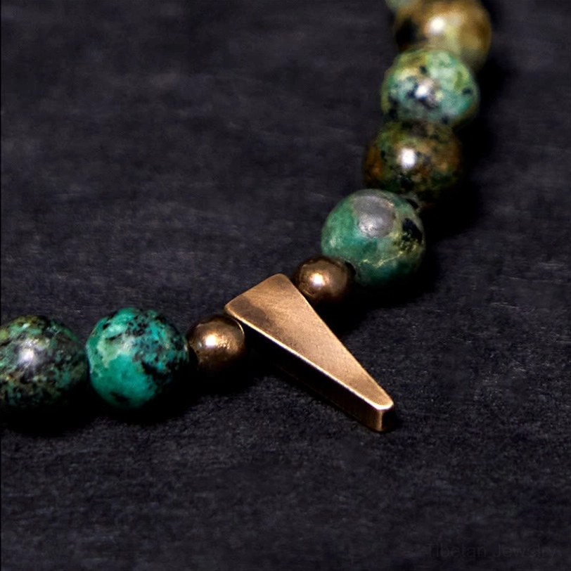 Macro close-up of turquoise beads and copper hardware showing natural stone texture and detail