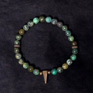 Turquoise copper spike bracelet detail shot showing long copper pendant and natural stone beads