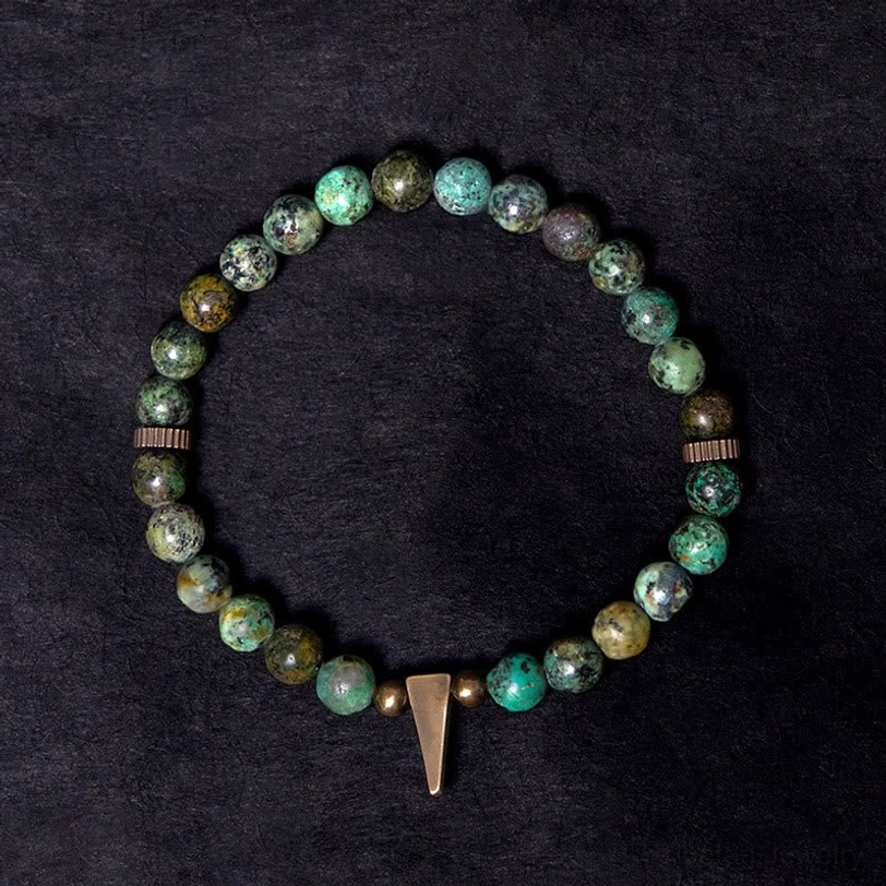 Turquoise copper spike bracelet detail shot showing long copper pendant and natural stone beads