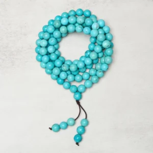 Handcrafted turquoise mala necklace displaying natural stone bead variations and authentic matrix patterns - overhead flat lay photography