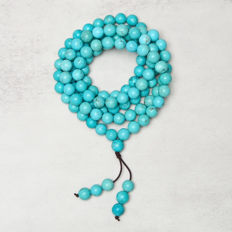 Handcrafted turquoise mala necklace displaying natural stone bead variations and authentic matrix patterns - overhead flat lay photography