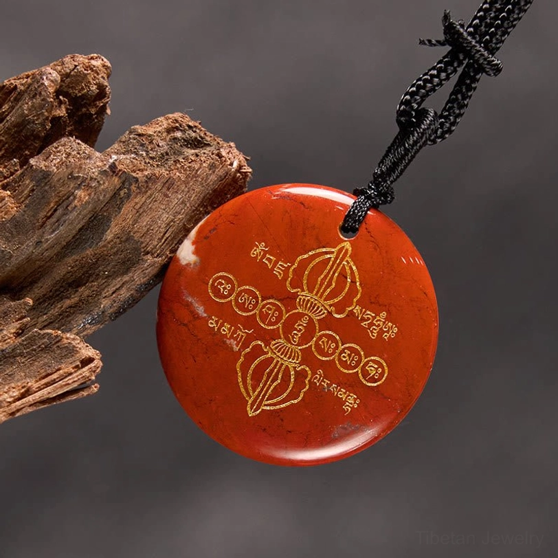 Vajra Dorje Tibetan crystal necklace pendant with golden Sanskrit engravings and spiritual meaning