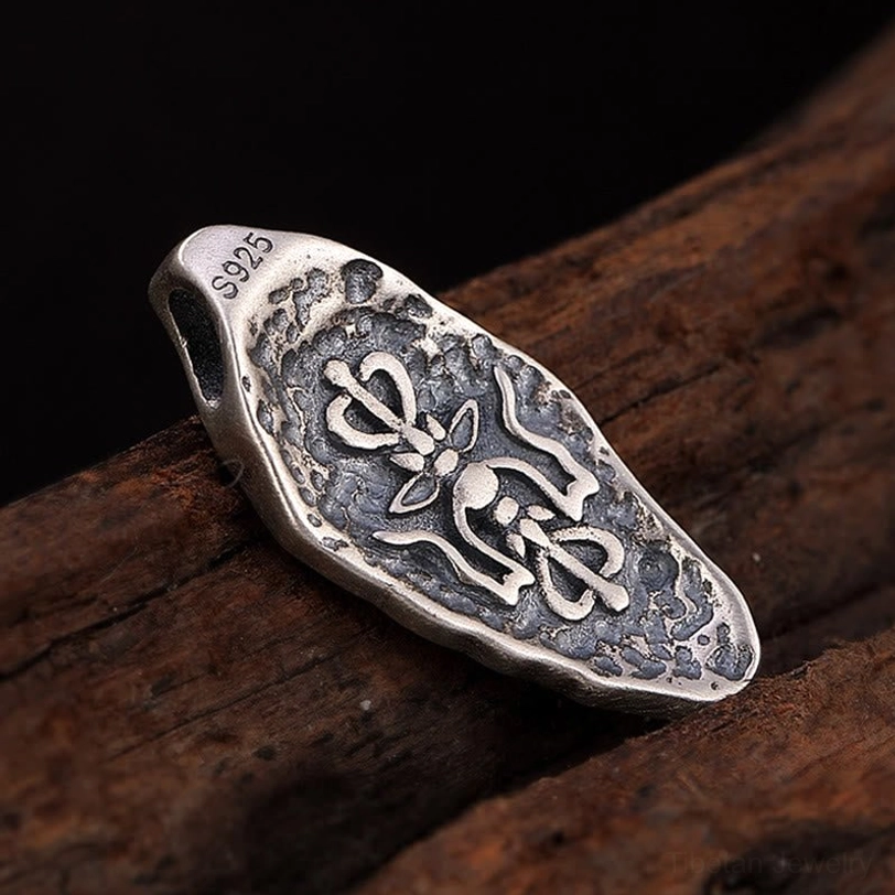 Tibetan Vajra Dorje symbol engraved on 925 sterling silver pendant with S925 mark on edge, front-top view