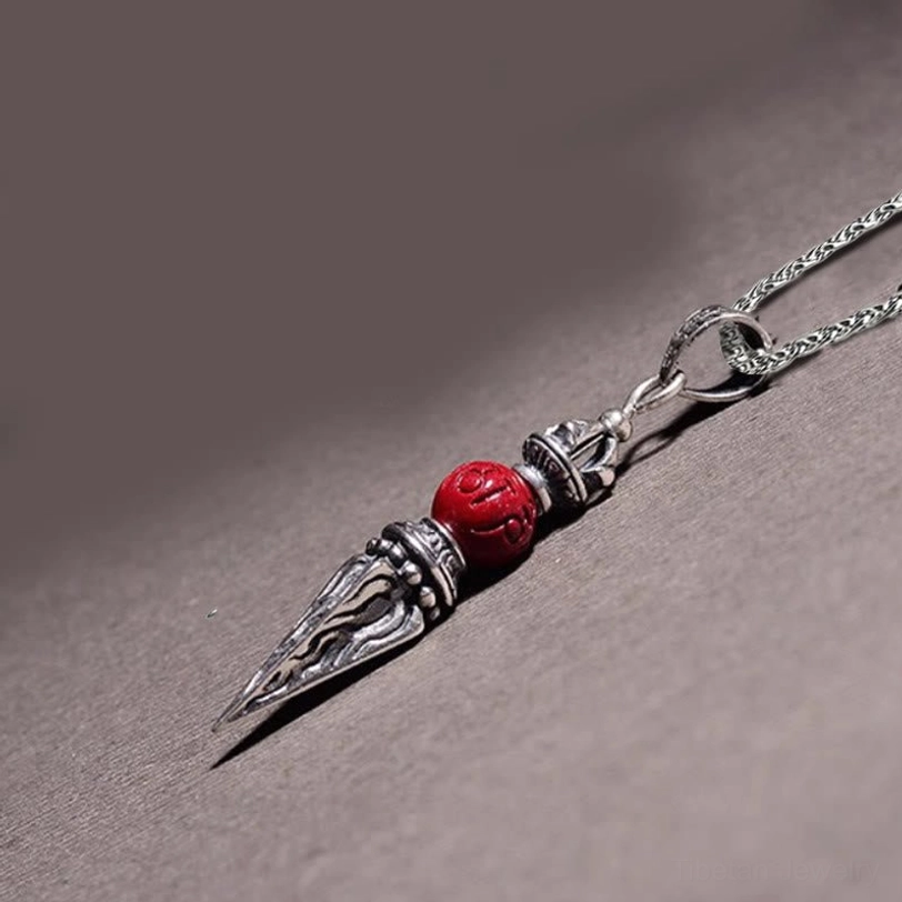 Vajra pendant flat side profile showing engraved silver body with red cinnabar accent and chain connection