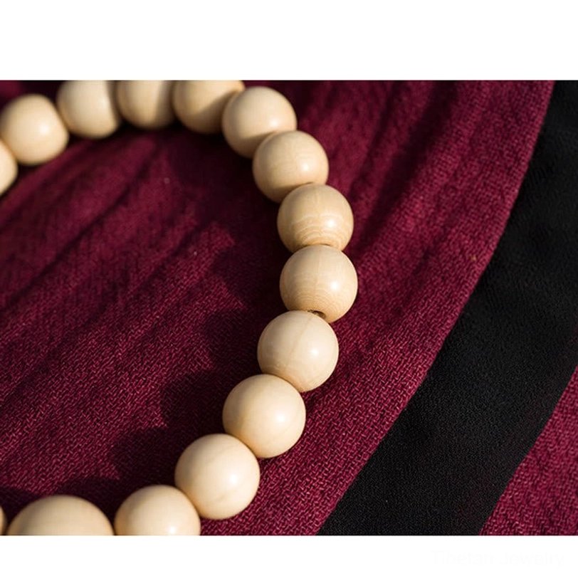 Tibetan Abelia Biflora wood prayer bracelet lifestyle shot showing wrist wear positioning and everyday spiritual practice application