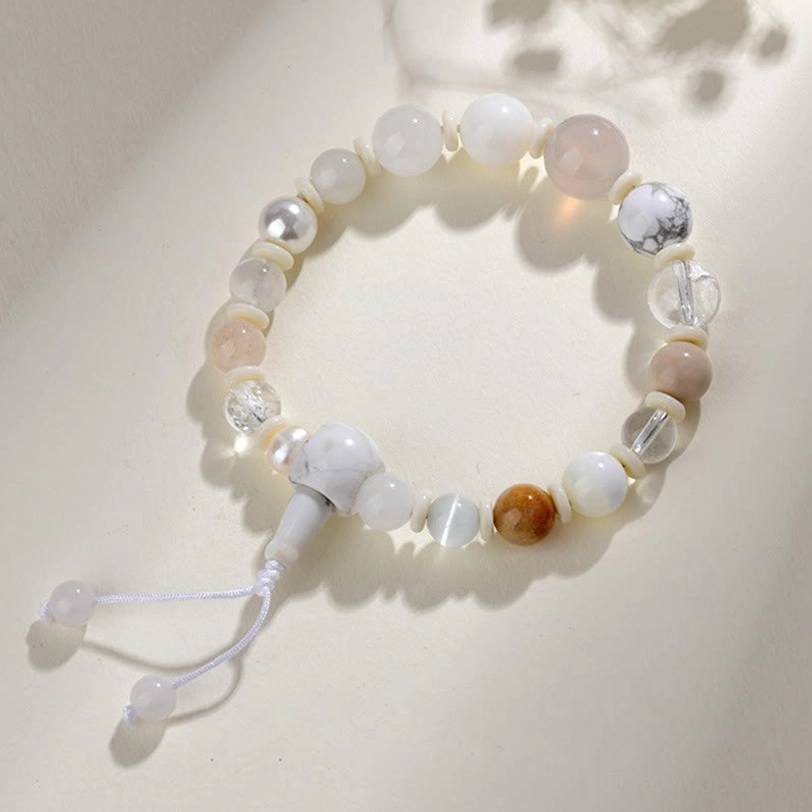 18-bead stretch bracelet with white agate and pearl - side view showing natural stone beads and adjustable tassel closure