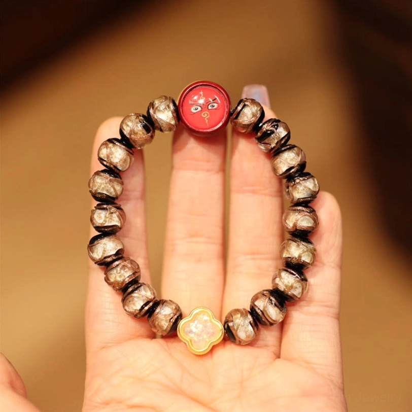White Black Red God of Wealth Tibetan bracelet with contrasting beads and fortune charm on elastic cord