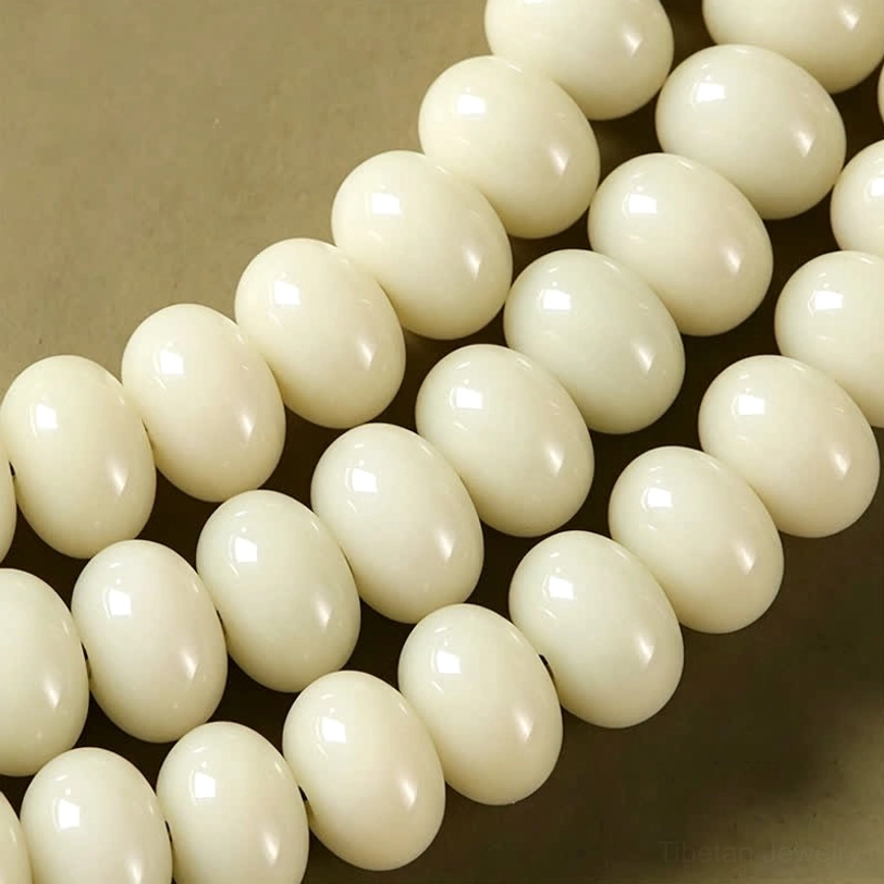 Authentic white bodhi seed mala with carved tassel showing traditional Tibetan Buddhist craftsmanship