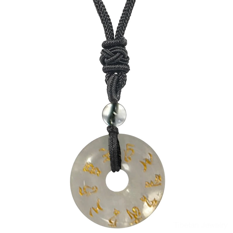 White Crystal Clear Quartz Green Tara mantra pendant close-up, featuring translucent stone with golden Sanskrit engraving and black braided cord