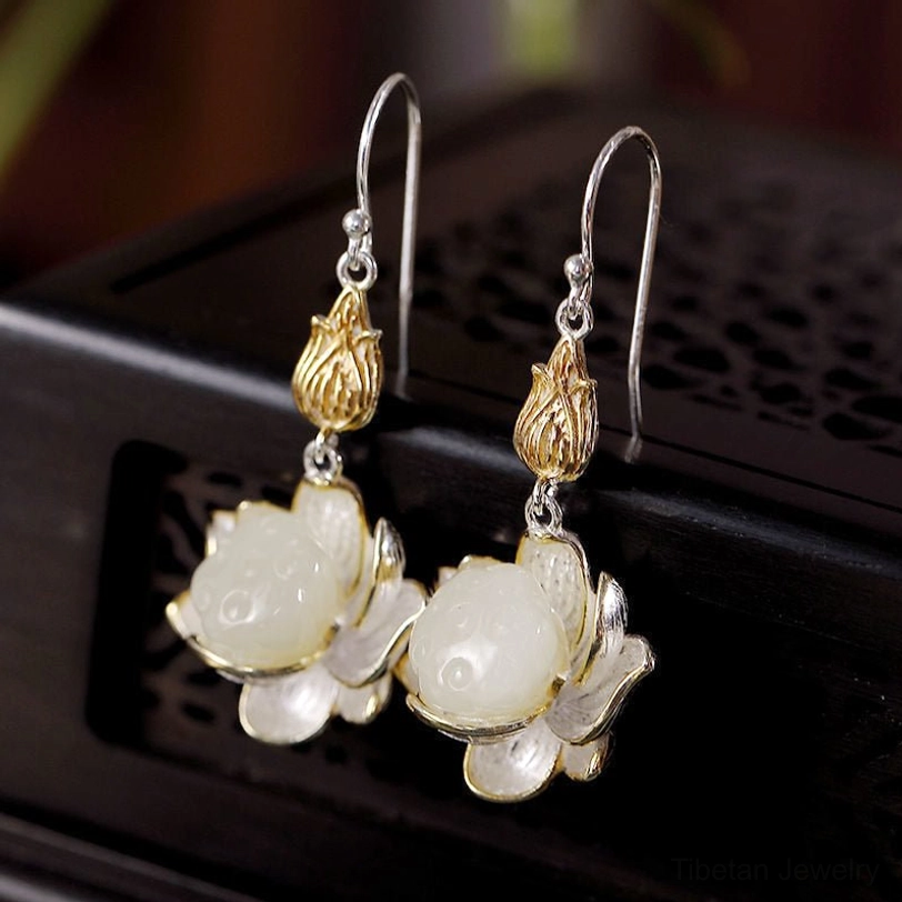 White jade lotus earrings detail shot highlighting handmade carving and natural stone texture variations
