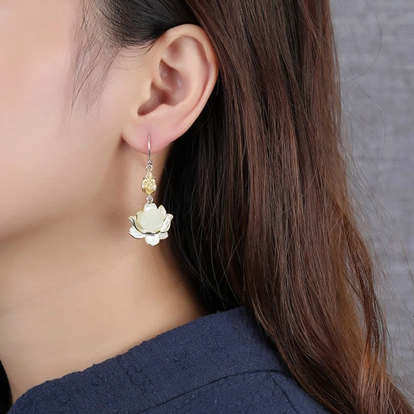 Single white jade lotus earring worn on model ear showing delicate handmade craftsmanship and subtle gold silver details