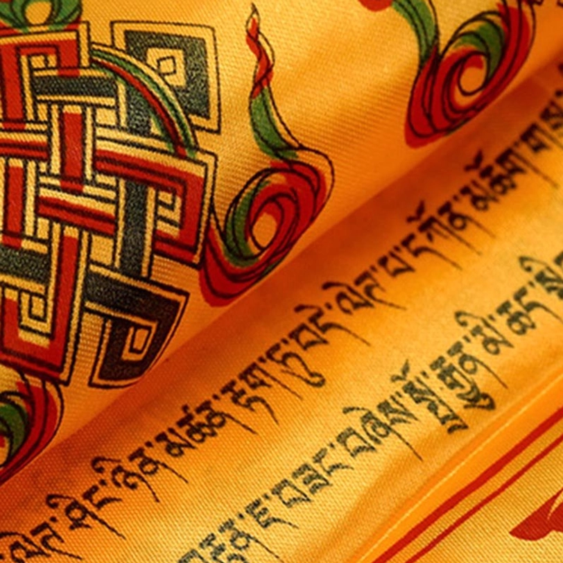 White Tibetan khata scarf with sacred Buddhist motifs, purity symbolism, and decorative tasseled hem on smooth satin fabric