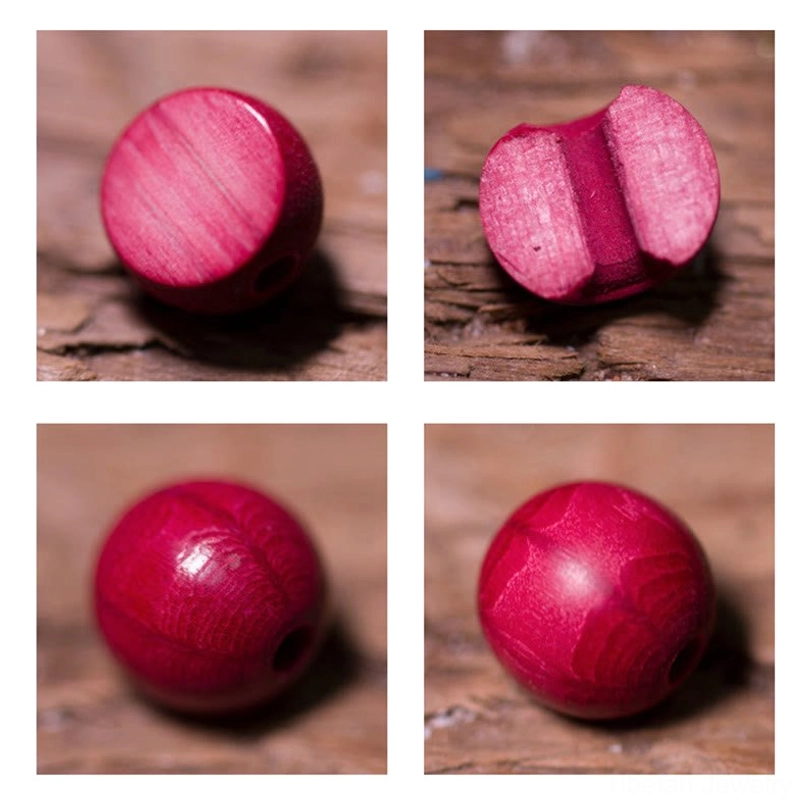 Abelia biflora wooden bead side view showing matte red finish and natural drilled hole against wooden table background