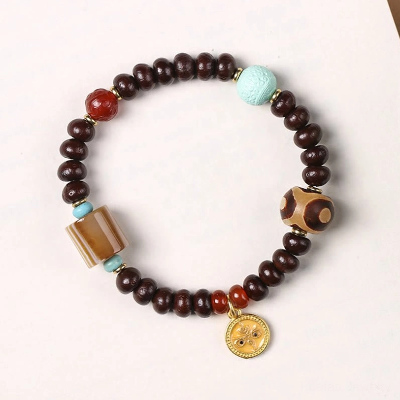 Yellow God of Wealth Dzi bead bracelet with purple bodhi seeds, three-eye striped agate dzi, red agate, turquoise, and round gold charm