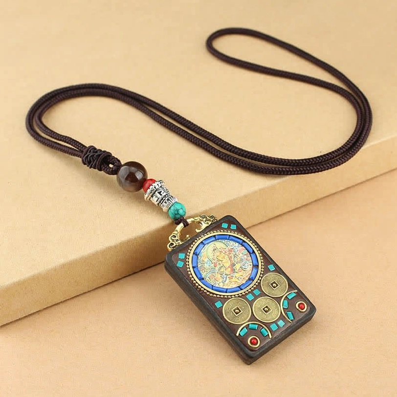 Yellow God of Wealth Tibetan thangka pendant with circular deity art, gemstone and brass coin embellishments