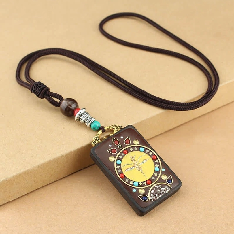 Yellow Tibetan God of Wealth thangka pendant with hand-carved ebony wood and traditional blessing design