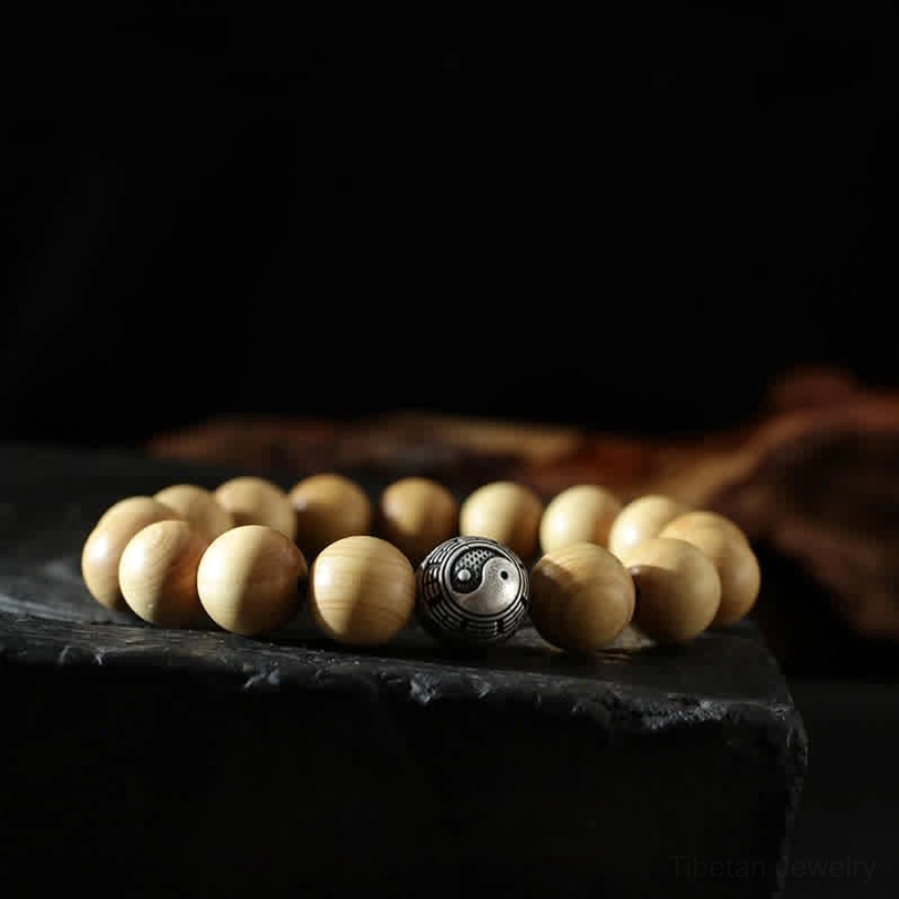 Yin yang balance bracelet - 12mm peach wood beads with engraved silver yin yang spacer detail
