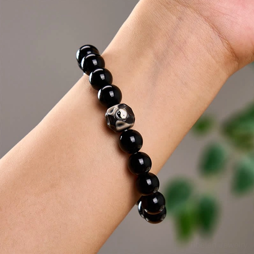 Tibetan Yin Yang protection bracelet styled on wrist showing comfort fit and charm visibility