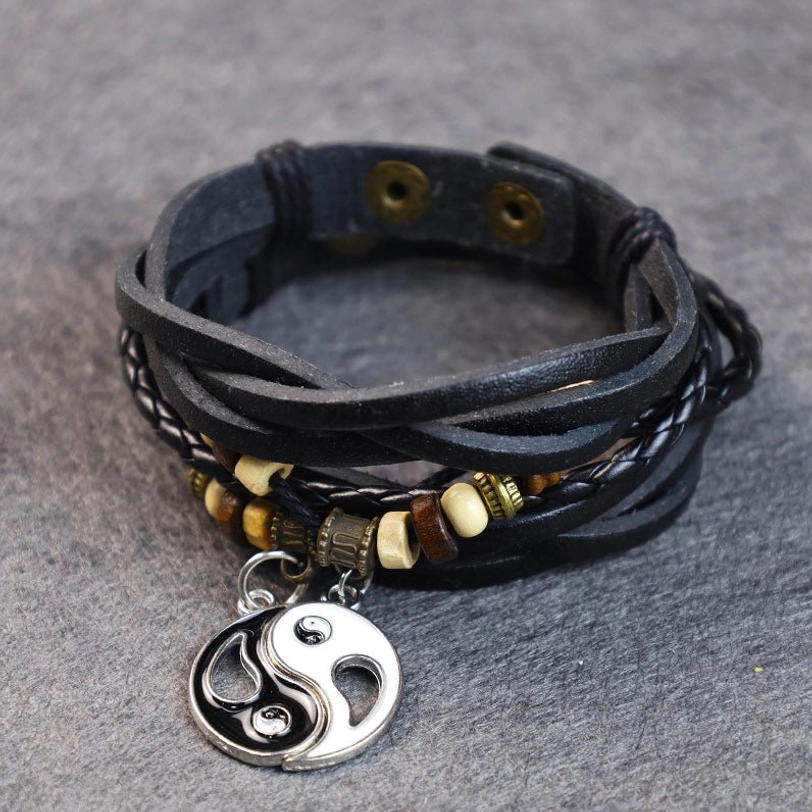 Handcrafted yin yang charm bracelet with braided leather strap and silver pendant
