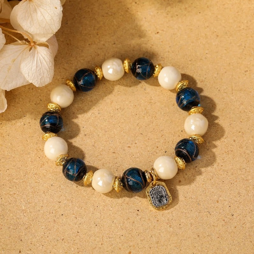 Blue liuli glass paired with beige porcelain in authentic Tibetan Zakiram goddess bracelet