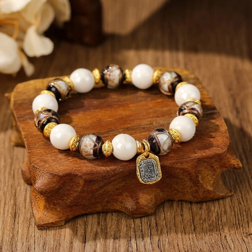 Marbled grey-brown Tibetan charm bracelet with white porcelain beads and patterned glazed beads