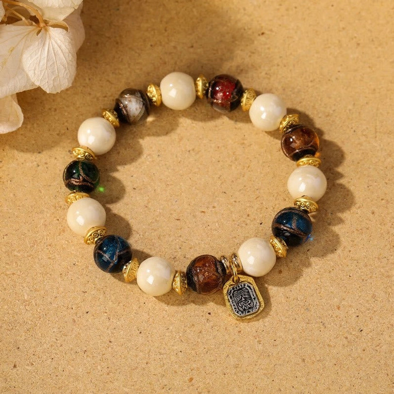 Multicolored liuli glass beads with white porcelain creating vibrant Tibetan Zakiram charm bracelet