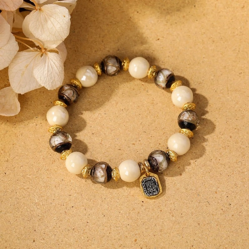 White porcelain and white liuli glass Tibetan Zakiram bracelet showcasing pure minimalist aesthetic
