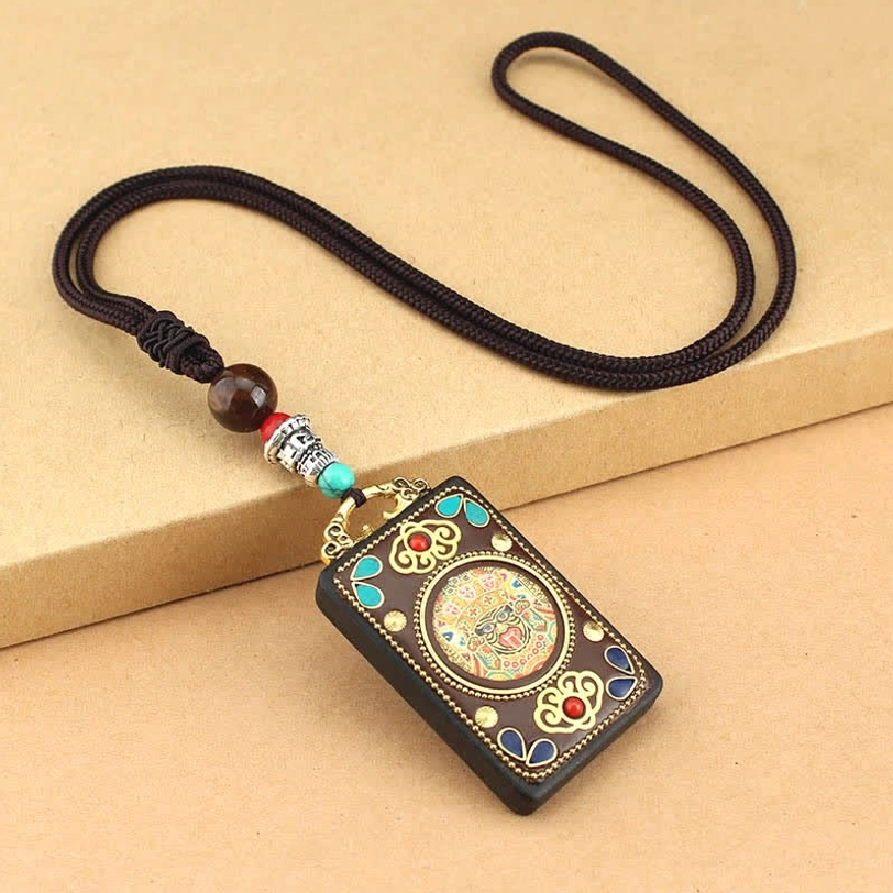 Zakiram God of Wealth Tibetan thangka pendant featuring wealth deity iconography and premium ebony wood construction