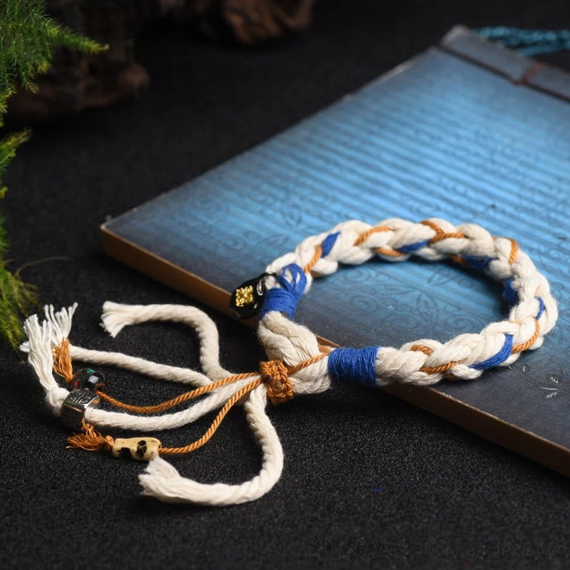Zakiram Goddess of Wealth bracelet with decorative tassel fringe and braided cord showing authentic handcrafted details