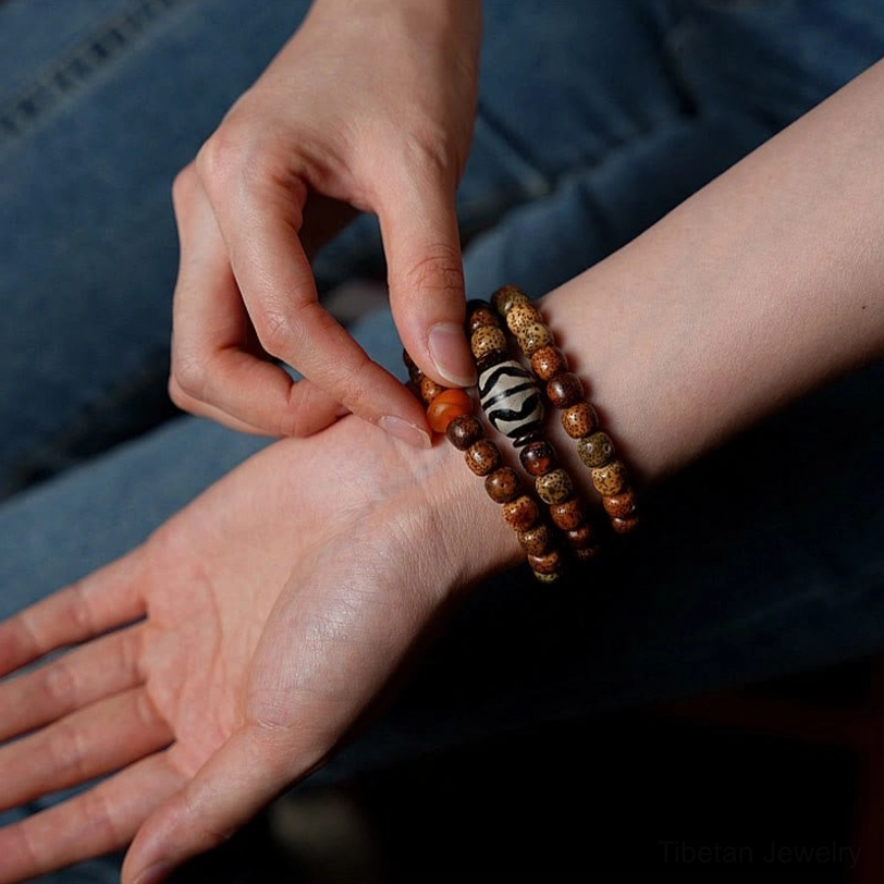 Zakiram Goddess of Wealth Tibetan bracelet handcrafted with bodhi seeds, amber, and agate for enlightenment and prosperity