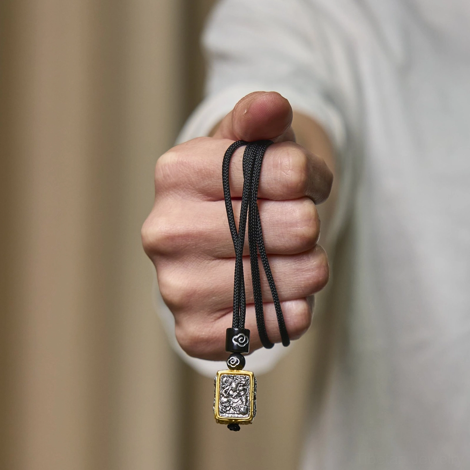 Zakiram fierce protector goddess tibetan pendant necklace, handcrafted square relief pendant with bicolor finish, black braided rope and decorative cloud-patterned spacer beads