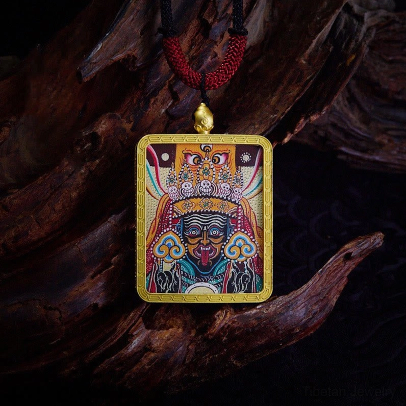 Red Zakiram protective deity thangka pendant with hand-painted red goddess design and gold frame - amulet for prosperity and safety