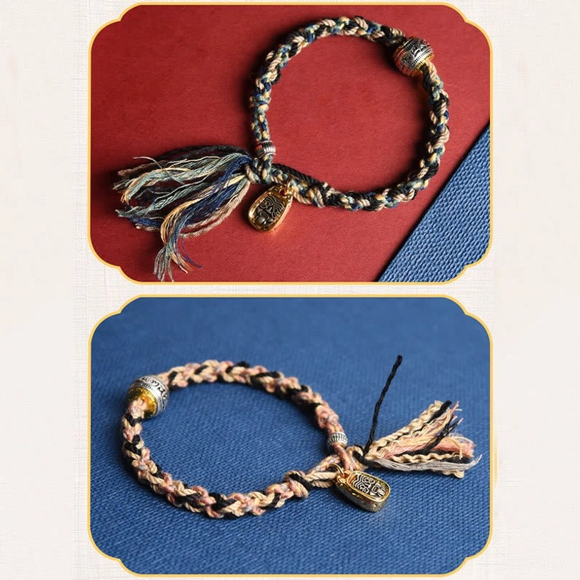 Two Tibetan Zakiram bracelet style variations dark mixed cord and tan braided cord both featuring gold pendants silver beads and tassels