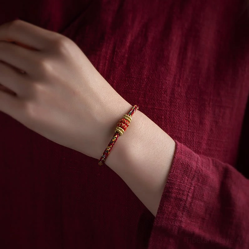 Handmade Tibetan zodiac natal Buddha bracelet worn on wrist, side view showing slim design