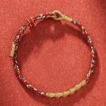 Handmade Chinese Zodiac Natal Buddha red string protection bracelet with gold braided trim and twisted weave detail